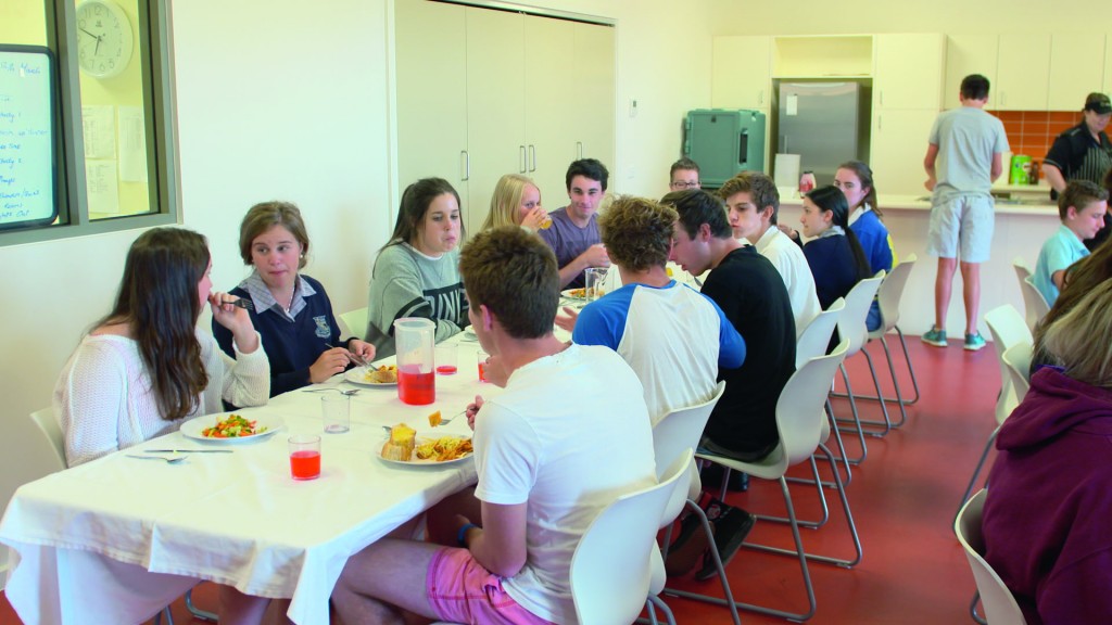 life skills from boarding schools. boarding students at dinner table.