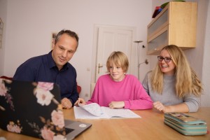 child succeed in high school. parents helping child on computer. parents helping school child.