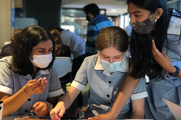 science in Australian schools. girls playing with science technology tools.