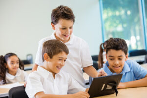 Preteen Private School Boys Using Digital Tablet Technology In Class